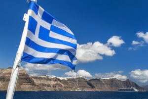 Greece flag waving against blue sky