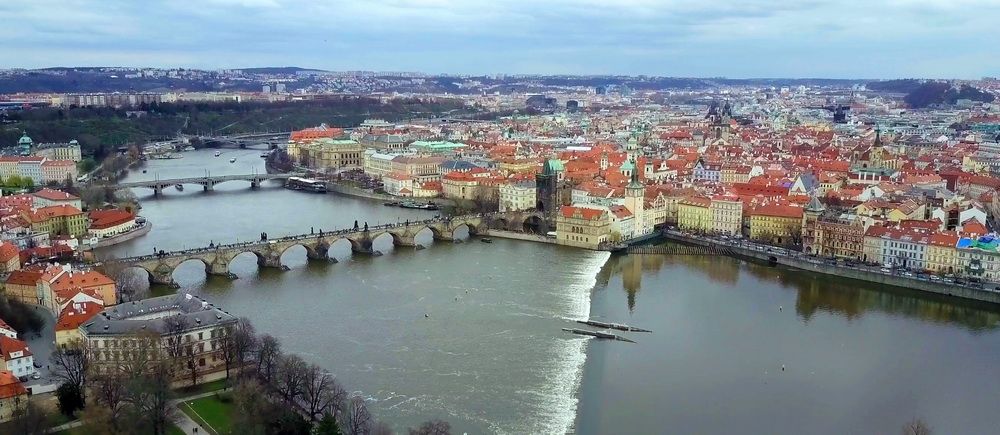 Evening panorama of Prague with illuminated bridges and castle