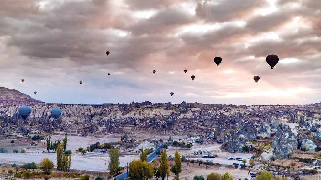 Hot air balloons floating over Cappadocia's valleys