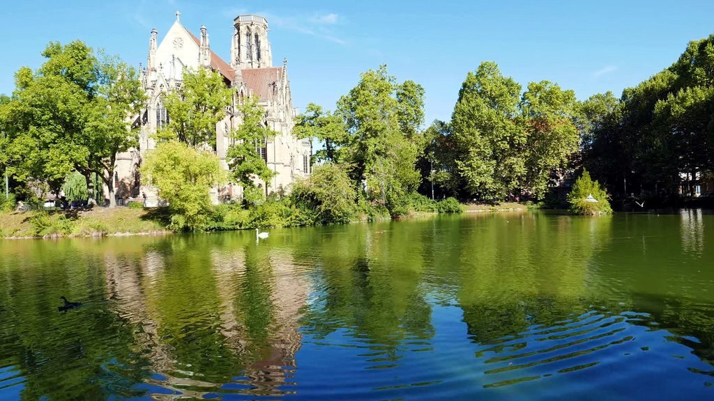 St. John's Church Neo-Gothic architecture beside artificial lake in Stuttgart, Germany