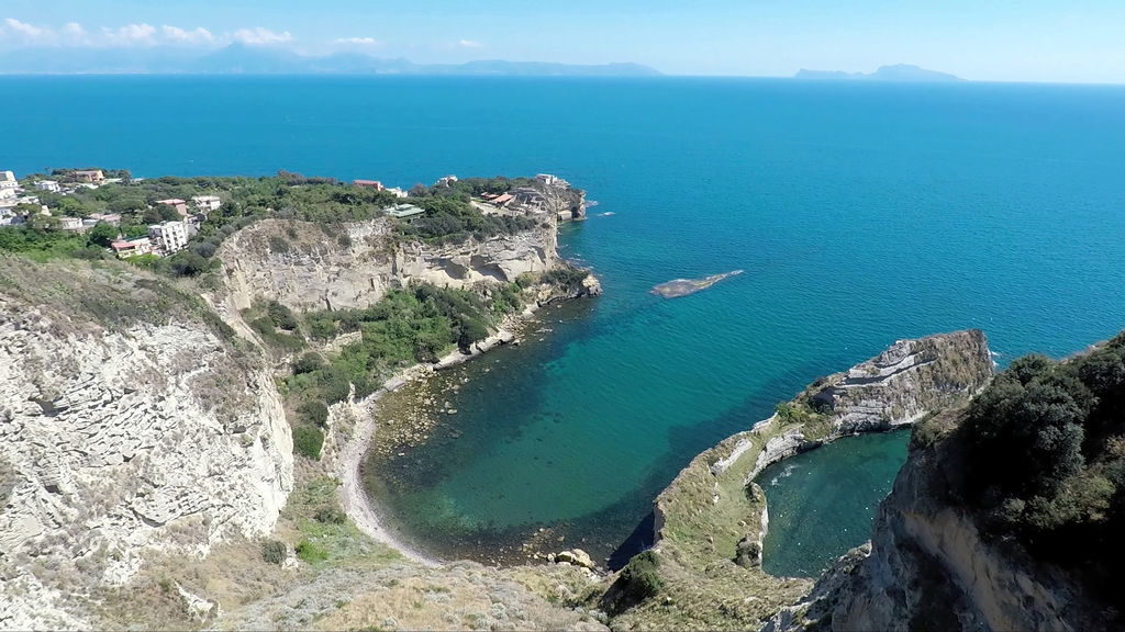Scenic coastline of Naples with boats and clear waters