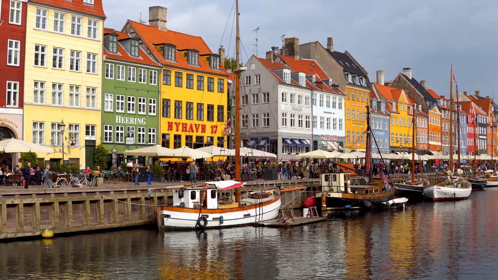 Colorful historic houses and boats along the Nyhavn canal in Copenhagen