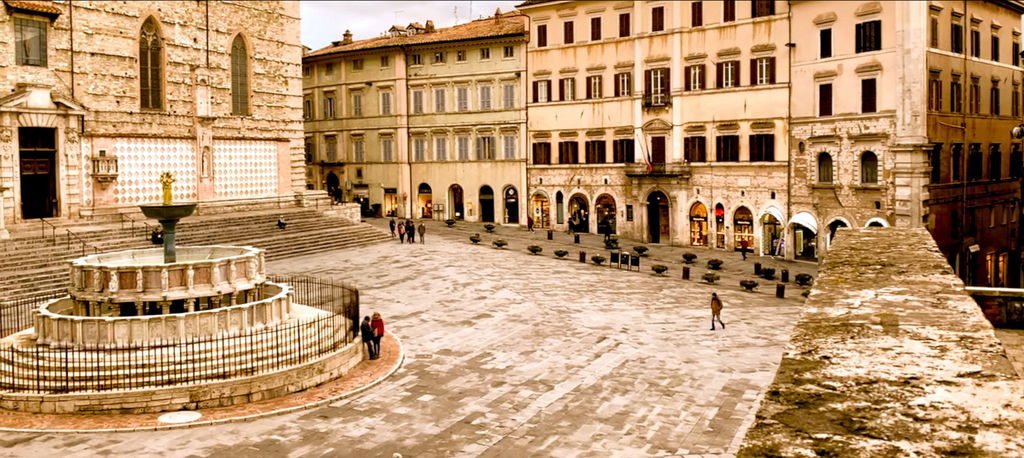 Piazza IV Novembre with historic buildings and fountain