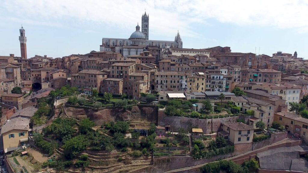 Panoramic view of Siena Italy showing rooftops and Tuscan landscape