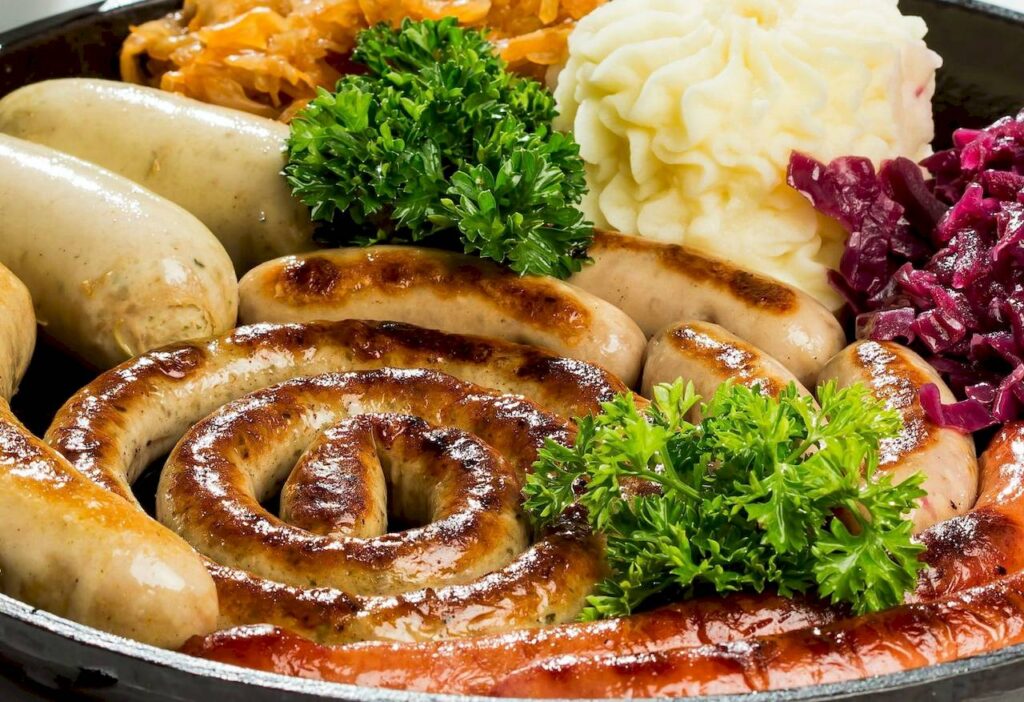 Traditional Bavarian Weisswurst served with sweet mustard and pretzel