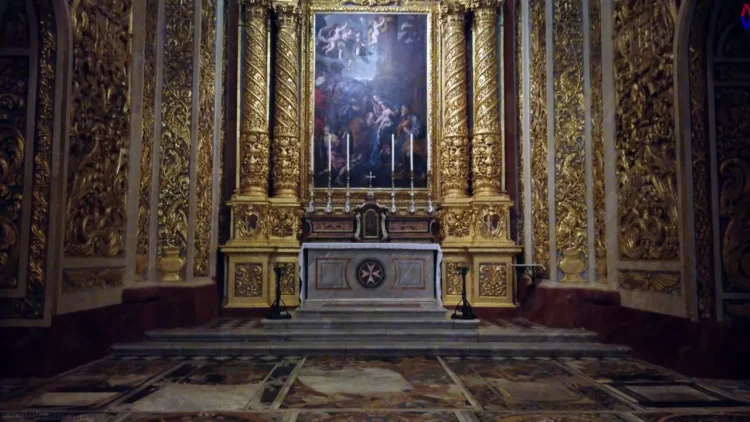 Ornate interior of St. John's Co-Cathedral in Valletta, showcasing baroque architecture and gold decorations
