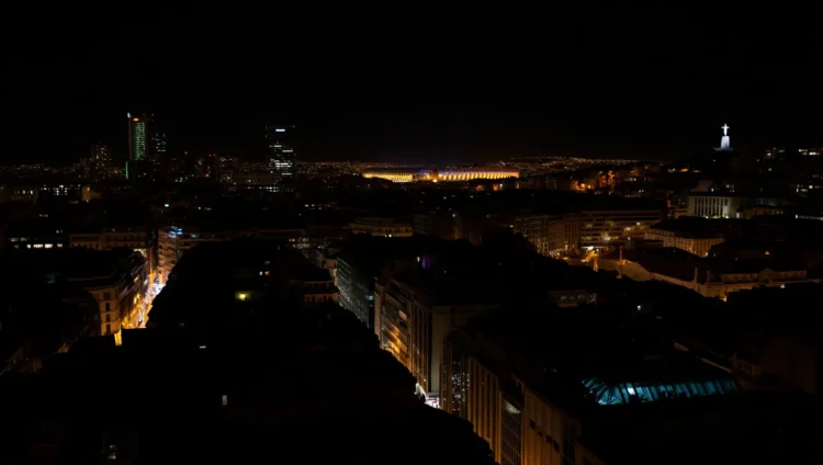Dark streets of Madrid during the massive blackout on April 28, people with flashlights at intersections without traffic lights