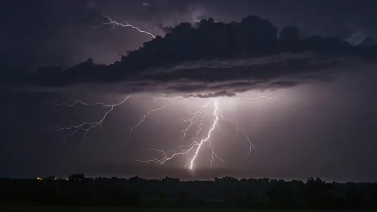 Stunning lightning bolt in night sky with dramatic clouds
