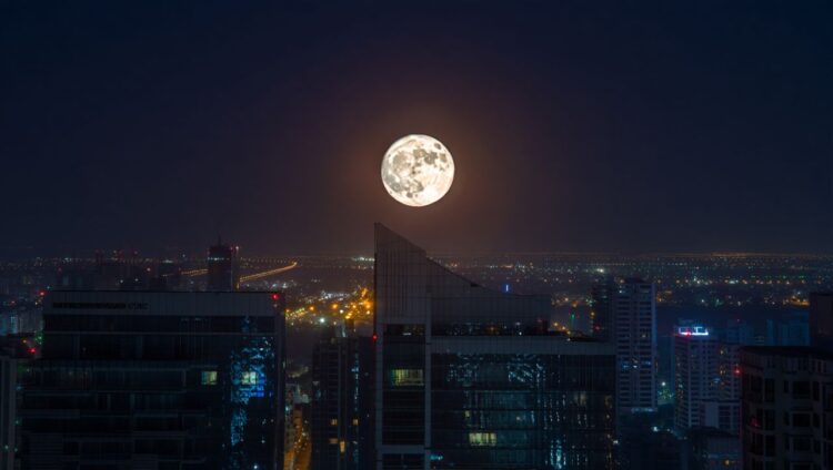 A stunning optical illusion of a supermoon, where the bright full moon appears enormous as it rises over the dark silhouettes of trees and buildings on the horizon.