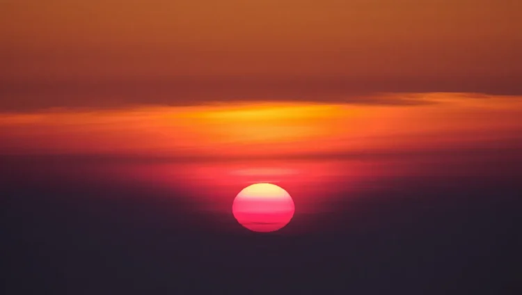 Bright crimson sunset caused by dense dust particles