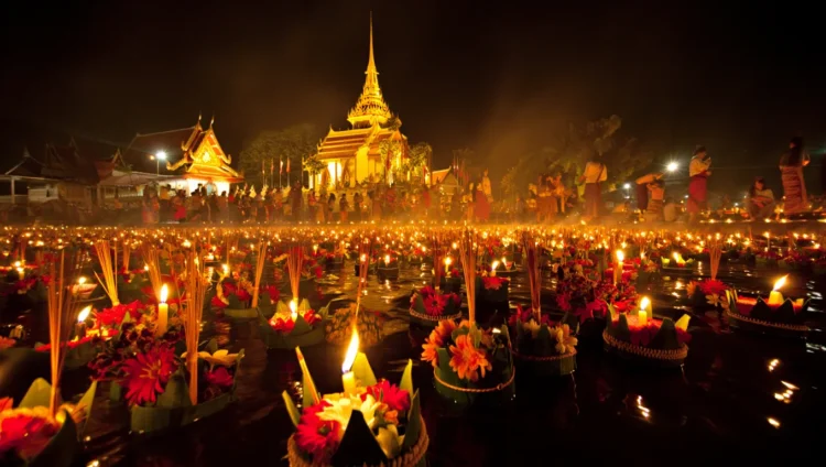 Loy Krathong Festival in Thailand with floating lanterns on water at night