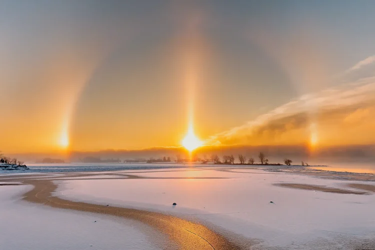 Halo effect creating light ring around sun in winter sky