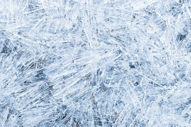 Ice needle crystals falling from clear sky in extreme cold