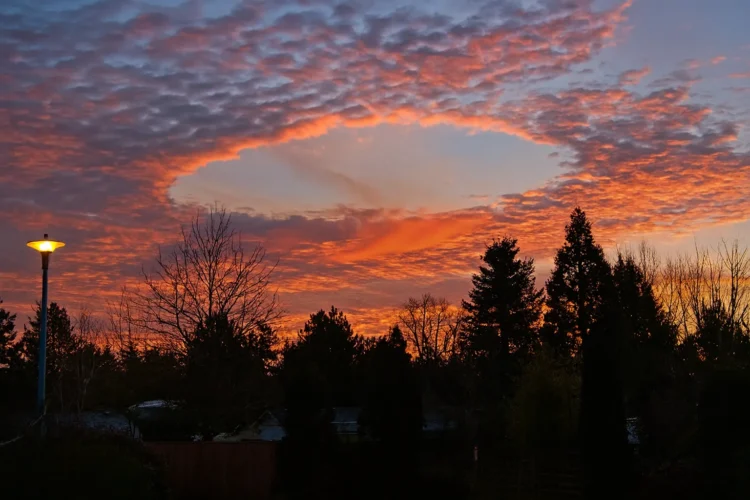 Fallstreak hole showing circular gap in clouds with precipitation