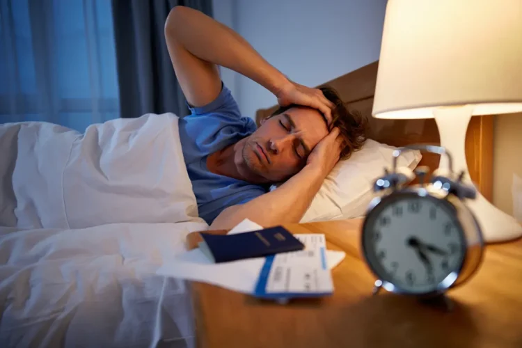 Man experiencing jet lag symptoms looking tired at airport after long flight
