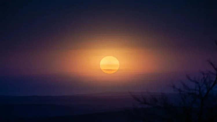 Orange Harvest Moon over a turbulent ocean representing chaotic climate conditions