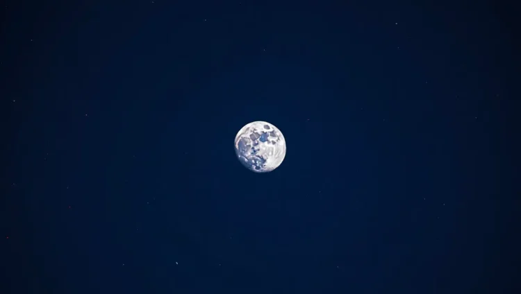 Full Moon shining in the night sky above Earth's atmosphere